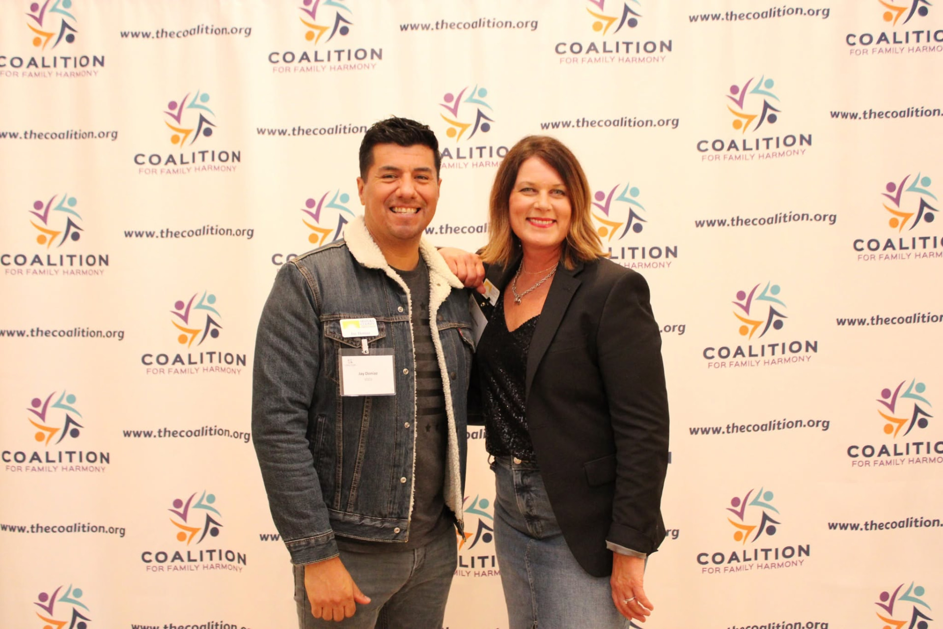 Guests in front of the Coalition for Family Harmony step-and-repeat banner