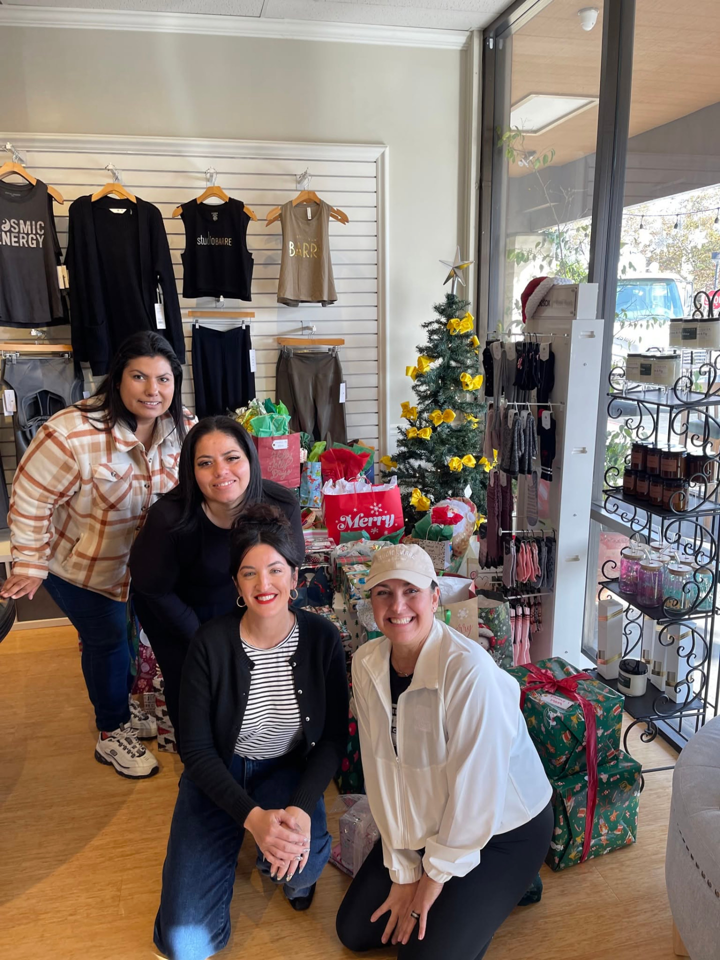 Coalition advocates with community partners beside a holiday gift collection