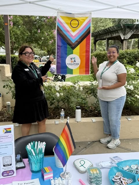 Coalition advocates at an LGBTQ+ Pride outreach table