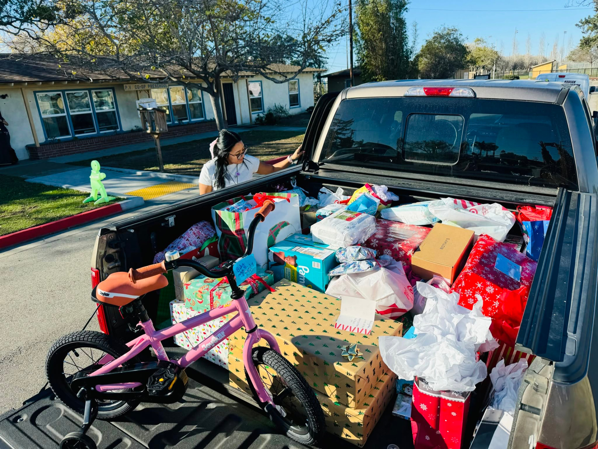 A truck bed filled with wrapped holiday gifts collected for survivor families