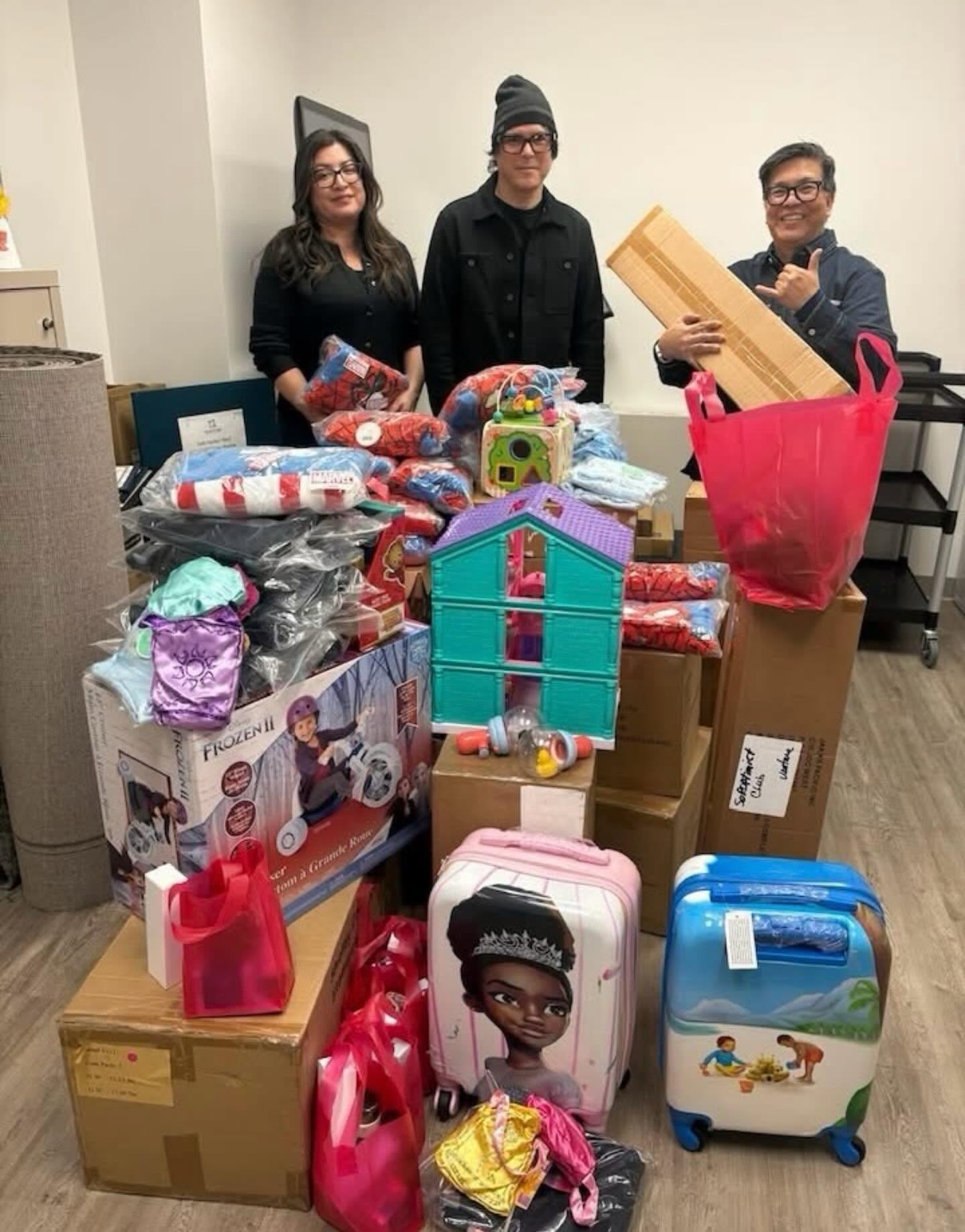 Coalition staff with donated toys and gifts for survivor families