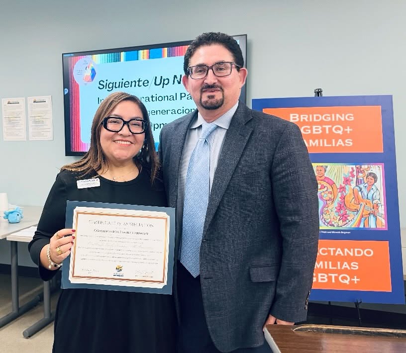 Coalition staff receiving a certificate of appreciation at a Bridging LGBTQ+ Familias event