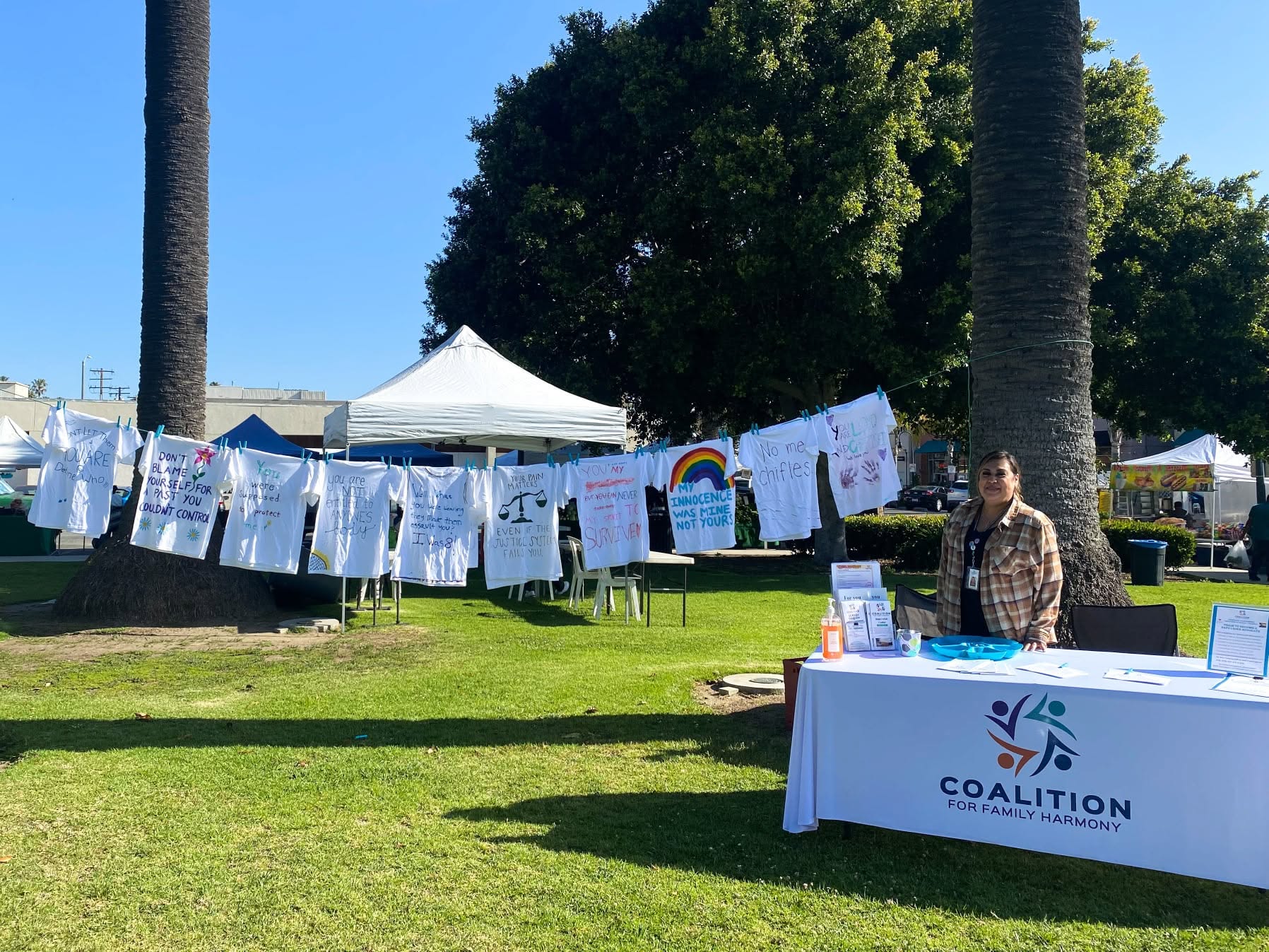 The Clothesline Project display of survivor-decorated shirts in a Ventura County park